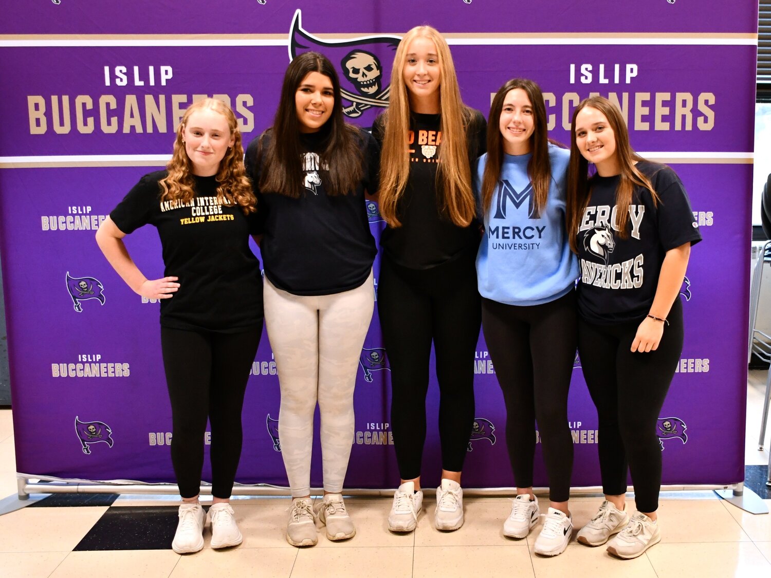 Islip High School seniors Dakota Dieumegard, Keira Jantz, Kathryn Lettieri, Lauren McSweeney and Carley Mullins signed letters of intent to play college athletics during a Nov. 9 ceremony.